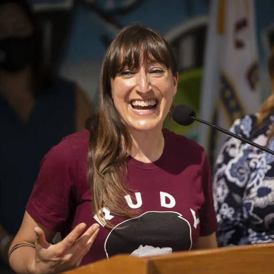 Jennifer Ventimiglia speaking into a microphone connected to a podium